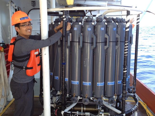 Hernanco Bacosa aboard the R/V Pelican in May 2013, collecting water samples for hydrocarbon and microbial analysis and an incubation experiment. Bacosa is preparing the Niskin bottles mounted on a conductivity-temperature-depth (CTD) array prior to deployment. (Photo provided by Bacosa)
