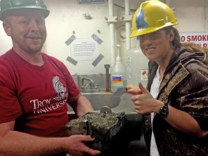 Ceil and lab mate Jonathan Miller display the sediment they collected for their meiofauna research. (Photo courtesy of Ceil Martinec)