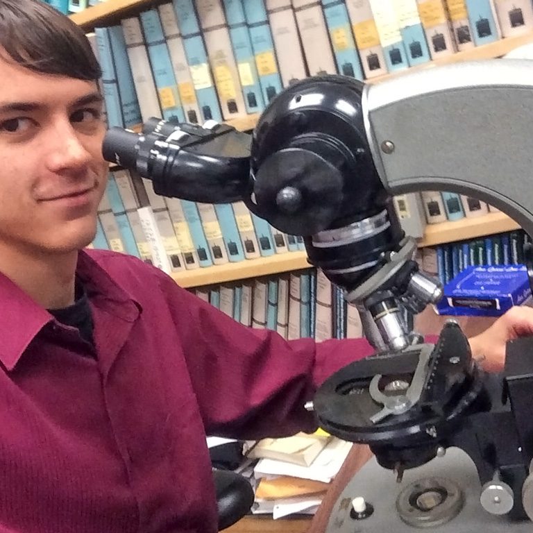 Jarrett Cruz examines nannoplankton samples under a microscope. (Photo provided by Jarrett Cruz)