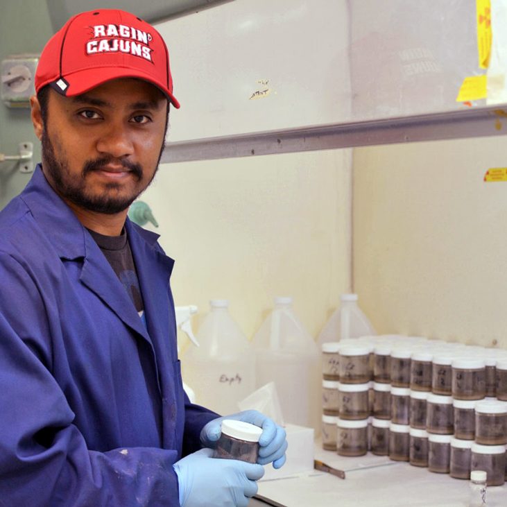 Nihar conducts a 14C-radiolabeled naphthalene assay in a radioactive laboratory to determine naphthalene degradation rate using sediments after each greenhouse microcosm experiment. (Photo credit: Suchandra Hazra)