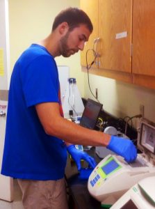 Bryan prepares a polymerase chain reaction to determine bacterial abundance in sea surface microlayer samples taken from the Florida Strait and Gulf of Mexico. (Photo credit: Cayla Dean)
