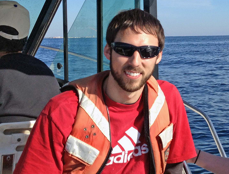 Bryan traveled to a Florida Strait sampling site to collect bacteria. He analyzed these samples to identify differences between microbial communities in the sea surface microlayer and underlying subsurface water. (Photo credit: Alexander Soloviev)