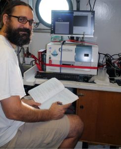 Adam Boyette looks at FlowCAM imagery and makes notes on the organisms that appear. This instrument collects images of all marine microplanktoninc organisms (20-200 micrometers) and can be used to identify certain phytoplankton species. Researchers analyze these images with other parameters such as temperature, salinity, depth, and location which provides researchers a way to monitor marine conditions. (Photo courtesy of CONCORDE)