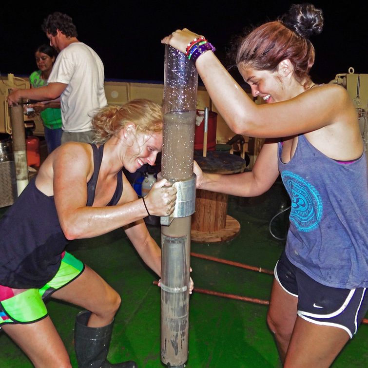 JSClark&KalinCore_Firesinger_SE_small Undergraduate students Nichole Clark (left) and Rachael Kalin (right) transfer a sediment core aboard R/V Justo Sierra. (Provided by C-IMAGE)