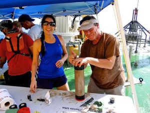 David Hollander and Isabel Romero show a sediment core they collected. The core will be cut open and analyzed to determine the composition of Gulf sediment at different points in history. (Provided by C-IMAGE)