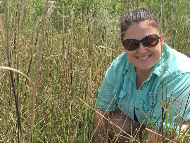 Elizabeth Robinson enjoys field work in Terrebone Bay studying blue crab in their natural habitat. (Photo provided by E. Robinson)