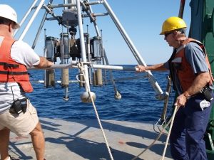 Gregg Brooks (R) assists in retrieving a multicore aboard the R/V Weatherbird II, November 2010. (Photo courtesy of Ben Flower)
