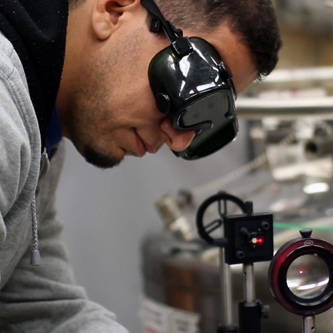 Bassam Alfarhani aligns the laser beam of the multidimensional luminescence system. (Provided by Andres Campiglia)