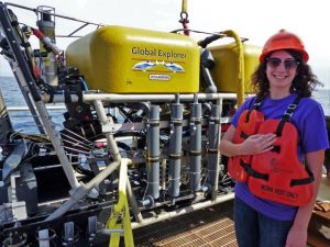 Fanny stands in front of the ROV Global Explorer after a successful dive. She uses ROVs to image corals and collect different types of samples, including coral, water, and sediment. (Photo by Cherisse DuPreez)