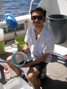 Co-author (and former NOAA NGI Diversity Program intern) Jeff Fang rinses a plankton sample at sea. (credit: USM Fisheries Oceanography and Ecology Lab)