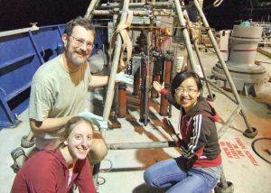 First Author Tingting Yang [right], thesis advisor Andreas Teske [left], and fellow graduate student Lisa Nigro [left] point to the multicorer full of seafloor sediments, onboard R/V Atlantis in the northern Gulf of Mexico, November 2010. Photo provided by Andreas Teske.