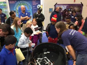 Kids at the Trip Elementary family STEM night drive a model ROV (remotely operated vehicle) and become an honorary member of the ECOGIG ROV pilot team. Photo by ECOGIG.