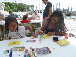 CARTHE has partnered with Vizcaya Museum and Gardens, Frost Museum of Science, and the Miami Science Barge for public involvement in research. Here, families paint drift cards which will be released as part of the CARTHE Drift Card Study tracking pollution in Biscayne Bay. Photo by CARTHE.