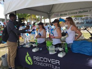 The RECOVER team at the 2017 Ocean Kids event talk about mahi-mahi and red fish research for a local media outlet. Photo by RECOVER.