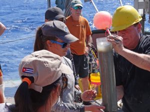 Marine geologist David Hollander (USF, right) instructs Cuban students on sediment core sampling techniques off northwest Cuba. Dr. Greg Brooks (Eckerd College, orange shirt) assists. Photo courtesy of C-IMAGE