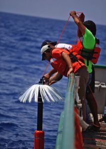 Team members deploy a microstructure device that measures fine-scale turbulence and dissipation at depth. Photo by Tamay Ozgokmen.