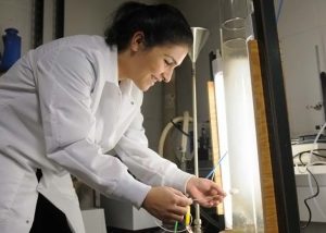 Co-author Paria Avij works with the bubble column reactor used in experiments to examine how two Corexit surfactants (DOSS, SPAN 80) each affect oil aerosolization. (Photo credit: The Daily Reveille)