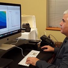 20171101_144905_slider Dr. Azmy Ackleh reviews modelling simulations of how environmental disturbances impact sperm whales. The contour plot on the left shows that a small change in survival rates over a long time period results in a large change in population dynamics. Photo provided by A. Ackleh.