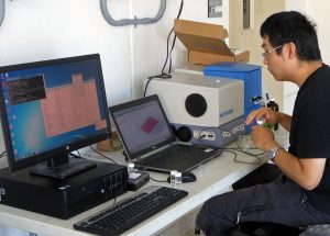 David takes fluorescence measurements to identify the presence of PAHs in his samples. (Provided by David Shi)