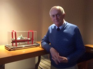 Peter Brewer stands next to a model of the International Scientific Cooperation of the Chinese Academy of Sciences’ new ship in Qingdao. Photo provided by P. Brewer