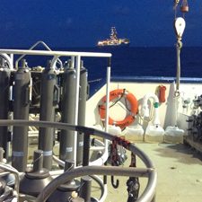CTD-Rosette_rig_slider Researchers used CTD and Niskin bottle rosettes to collect dissolved organic carbon samples aboard the R/V Pelican. In the distance is a nearby drilling ship on the Gulf of Mexico. Photo credit: Brad Rosenheim