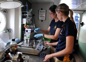 Danielle (front) and former Penn State University graduate student Dannise Ruiz work on coral exposure experiments aboard the 2013 R/V Nautilus cruise. (Provided by ECOGIG)