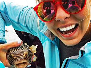 Meinert_slider Corinne Meinert holds a deep-sea fish collected during a research cruise. Corinne studies the biodiversity of fish eggs and larval fish that drift in ocean currents. (Provided by DEEPEND)