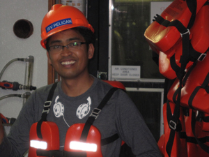 DROPPS_Liu_IMG_3621_slider Study author Hernando P. Bacosa onboard the RV Pelican collecting water samples from the Gulf of Mexico. Photo provided by Zhanfei Liu.