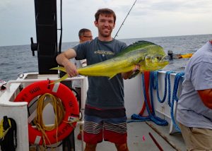 Travis holds a large mahi caught during a fishing break between sampling efforts. (Provided by DEEPEND)
