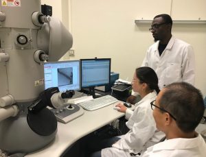 Tulane graduate students Marzhana Omarova (seated) and Igor Mkam Tsengam (standing) along with Dr. Jibao He (seated far left, Tulane’s director of electron microcopy) use the Transmission Electron Microscope in their research about dispersant gels. Photo provided by Vijay John.