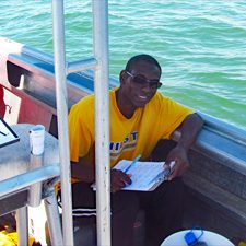 drifter_release_water_samples_pic1_slider Stephan O'Brien collects water samples at Main Pass, Alabama, for suspended sediment laboratory analyses. (Photo by Brian Dzwonkowski)