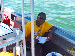 drifter_release_water_samples_pic1_slider Stephan O'Brien collects water samples at Main Pass, Alabama, for suspended sediment laboratory analyses. (Photo by Brian Dzwonkowski)