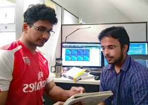 Aditya Aiyer explains the basic ideas of his research to a fellow student. (Provided by Aditya Aiyer)