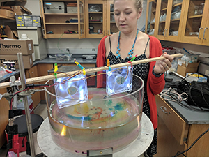 Jenna conducts a rotating tank experiment to illustrate Ekman dynamics for the Summer@Brown course “Studying the Ocean from Blackboards to Drones.” (Photo by Abigail Bodner)