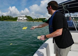 ohn Lodise releases drift cards near the Rosenstiel School campus for the BayDrift experiment, which studies pollution transport pathways off the coast of Miami and south Florida. (Photo credit: Diana Udel)