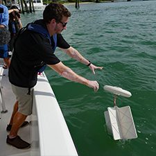 CARTHE_Scholar_JohnLidel_Baydrift_drifter_credit Diana Udel_RSMAS_slider John Lodise releases a drifter during a BayDrift experiment near the Rosenstiel School campus. (Photo credit: Diana Udel)