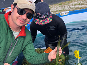 Pub_CWC_Martin_IMG_1802_slider Study author Charlie Martin assists with a recent experiment on submerged aquatic vegetation. Photo provided by Charlie Martin