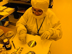 Study author Maryam Jalali inks the stamp with crude oil and then uses the inked stamp to print oil microdroplets. The stamp is a pre-textured polymer that contains cavities that can be filled with oil and is used to transfer or print oil to a smooth substrate. After printing, Jalali uses a microscope with high magnification to inspect the yield and quality of the droplets. Photo credit: Terry Brough at the Minnesota Nano Center.