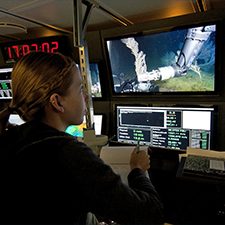 Pub_DeLeo_2937478_slider Study author Danielle DeLeo monitors coral sampling by a remotely-operated-vehicle in the control room of R/V Nautilus during the 2013 ECOGIG research expedition (Photo credit: ECOGIG).