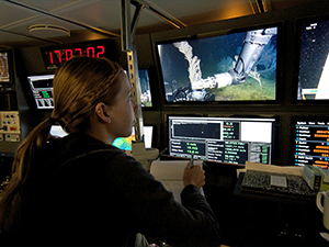 Pub_DeLeo_2937478_slider Study author Danielle DeLeo monitors coral sampling by a remotely-operated-vehicle in the control room of R/V Nautilus during the 2013 ECOGIG research expedition (Photo credit: ECOGIG).