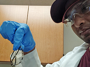 GopalBera_RFP5Knap_slider Dr. Gopal Bera, with the Geochemical and Environmental Research Group at Texas A&M University, displays a silicone tube filled with Macondo oil. This oil-filled tube is one of the passive dosing methods analyzed in this study for improved oil toxicity testing. Photo Credit: Kusumica Mitra