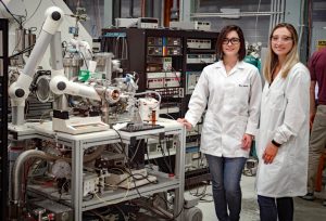 Dr. Martha Chacon (left) and Sydney Niles (right) stand next to the custom-built 9.4 Tesla FT-ICR MS used for molecular-level analysis of petroleum compounds. (Photo credit: Stephen Bilenky)
