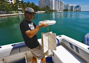 Matt Grossi prepares to deploy a CARTHE drifter into Biscayne Bay, Florida. (Photo Credit: CARTHE)