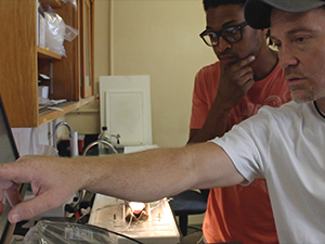 University of North Texas Associate Professor of Biology Dane Crossley (white shirt) and his graduate student Derek Nelson (a GoMRI Scholar) review cardiovascular data of oil-exposed early-life-stage fish. Credit Daniel DiNicola RECOVER consortium.