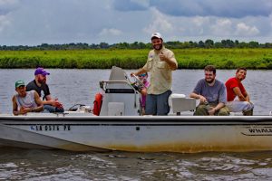(L-R) Master’s students Darrius Davis and Ben Aker, Ph.D. student Mike Becker, research associate Erin Stevens, master’s student Patrick Rayle, and worker Julian Lucero travel to Louisiana marshes for insect collection. (Photo credit: Claudia Husseneder)