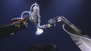 This image shows the gas bubble collection apparatus on the left and the remotely operated vehicle (ROV) sampling arm on the right. Cameras mounted on the ROV Hercules took this underwater photo. Credit: Ocean Exploration Trust, Inc.