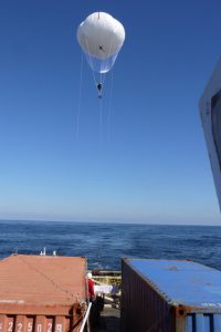 The Ship Tethered Aerostat Remote Sensing System (STARSS) rises above the M/V Masco VIII during the CARTHE Lagrangian Submesoscale Experiment (LASER), which tracked surface and near-surface currents for oil transport studies in the Gulf of Mexico . Photo credit: Maristella Berta (National Research Council-Institute of Marine Science, CNR-ISMAR, Venice, Italy).