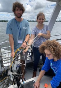 Ph.D. student Abigail Bodner (center) and Research Assistant Laura Messier (right) helps undergraduate student Daniel Gates (left) measure Narraganset Bay water properties during a Save the Bay cruise for Brown University’s Summer@Brown course “Studying the Ocean from the Classroom to the Bay”. (Photo by Jenna Pearson)
