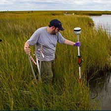 Patrick Rayle, a master’s student at Louisiana State University AgCenter, sets up a sample transect at a marsh site that has not experienced shearing. (Photo by Claudia Husseneder)