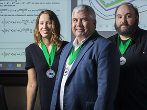 From left, Dr. Amy Veprauskas, Dr. Azmy S. Ackleh, and Dr. Ross Chiquet, recipients of the 2019 Rollie Lamberson Research Award. Not pictured are Dr. Tingting Tang and Dr. Hal Caswell. (Photo credit: Doug Dugas, University of Louisiana at Lafayette photographer, used with permission from Doug Dugas)